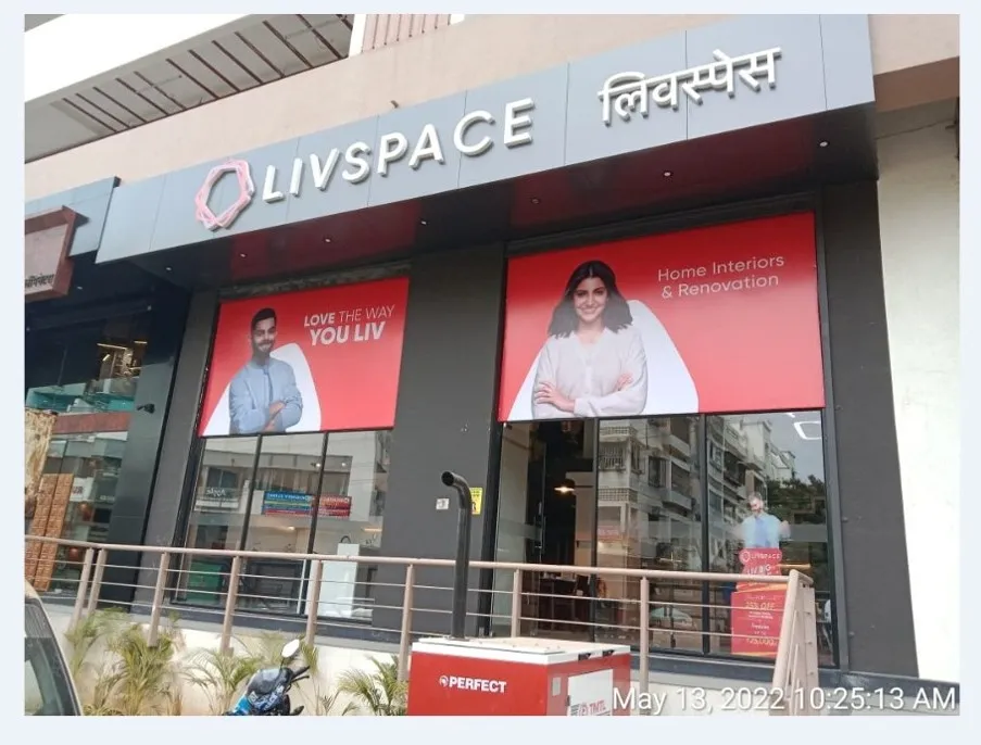 Branded retail storefront with a lit fascia sign and window graphics