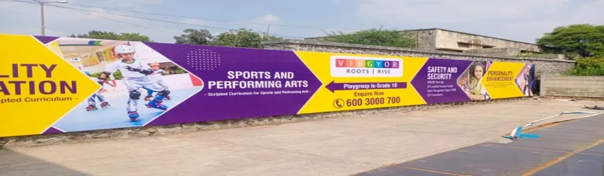 Long campus wall carrying a school admissions banner